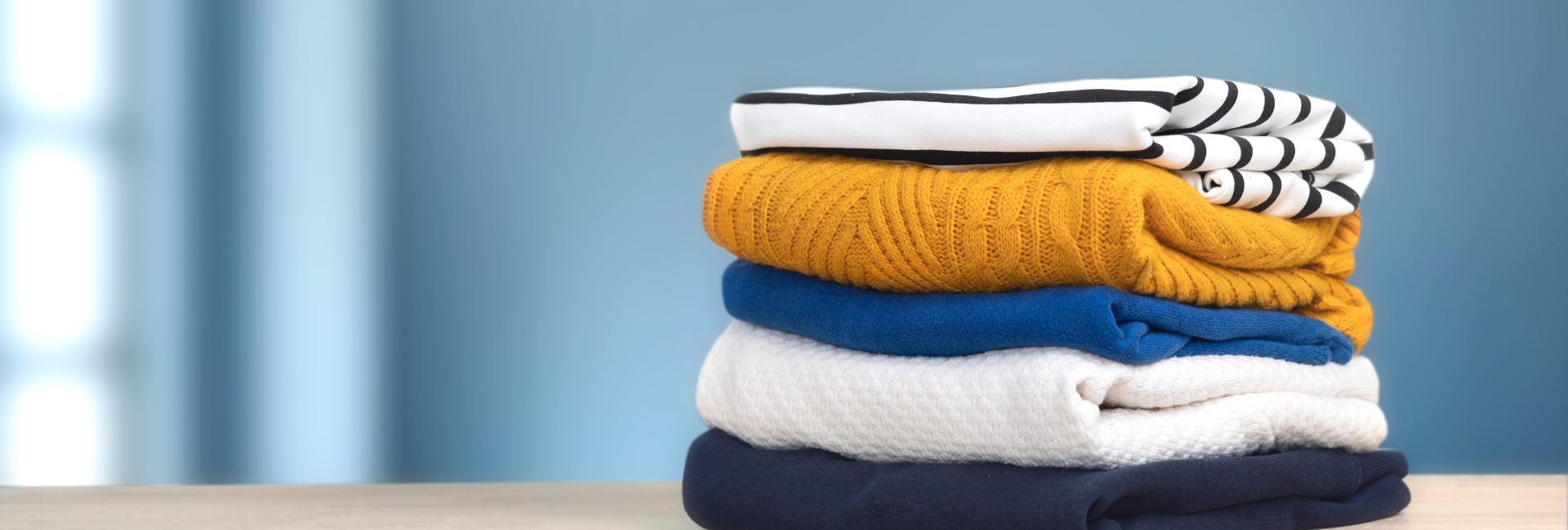 Stack Of Striped Shirt Orange Sweater And More 1920X650